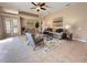 Spacious living room with tile flooring, neutral walls, ceiling fan, and modern furnishings at 23523 Gracewood Cir, Land O Lakes, FL 34639