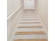 Bright staircase featuring white risers, natural wood treads and a white handrail at 23523 Gracewood Cir, Land O Lakes, FL 34639