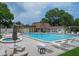 Inviting community pool area with lounge chairs and tables for relaxing and enjoying the outdoors at 2400 Winding Creek Blvd # 26-203, Clearwater, FL 33761