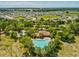 Aerial view of the community pool surrounded by lush trees in a residential area at 248 Argyll Dr, Spring Hill, FL 34609