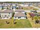 Aerial view of backyard featuring a playground, green grass, and fenced-in yard at 248 Argyll Dr, Spring Hill, FL 34609