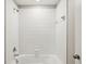 Clean bathroom featuring a white tiled shower and tub, offering a refreshing and modern bathing space at 248 Argyll Dr, Spring Hill, FL 34609