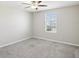 Cozy bedroom with soft carpet, a ceiling fan, and a bright window at 248 Argyll Dr, Spring Hill, FL 34609