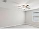 Bedroom features neutral walls, plush carpet, and a window with blinds. The room has a ceiling fan at 248 Argyll Dr, Spring Hill, FL 34609