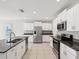 Modern kitchen with stainless steel appliances, granite countertops, and stylish white cabinetry at 248 Argyll Dr, Spring Hill, FL 34609