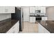 Well-lit kitchen features stainless steel appliances, granite countertops and tiled floors at 248 Argyll Dr, Spring Hill, FL 34609