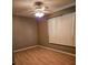 Bedroom showcasing wood-look flooring, ceiling fan, and natural light through window at 26419 Rolling Acres E Dr, Brooksville, FL 34602