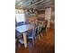 Dining room features a wooden table with mismatched chairs under a chandelier at 26419 Rolling Acres E Dr, Brooksville, FL 34602
