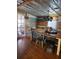 Dining room boasts wood floors, rustic wood accent wall and a multi-colored wood dining table at 26419 Rolling Acres E Dr, Brooksville, FL 34602