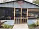 Unique outdoor entertainment space features screened-in porch with bar and seating near the pool at 26419 Rolling Acres E Dr, Brooksville, FL 34602