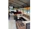 Covered outdoor seating area with comfortable furnishings and view of pool at 26419 Rolling Acres E Dr, Brooksville, FL 34602