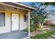 Close-up of the front porch featuring a white door and well-maintained landscaping at 2811 60Th N Ave, St Petersburg, FL 33714