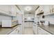 Cozy kitchen with bright white cabinets and plenty of counter space and modern lighting at 2811 60Th N Ave, St Petersburg, FL 33714