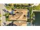 Expansive aerial view of a home with a uniquely shaped roof, screened-in pool, mature trees and lush, green landscaping at 3006 Christophers Watch Ln, Ruskin, FL 33570