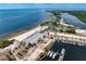 Stunning aerial view of waterfront property featuring a beach, marina, and lush greenery in a coastal community at 3006 Christophers Watch Ln, Ruskin, FL 33570