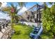 Waterfront property with lush landscaping and outdoor seating areas overlooking the water and marina at 3006 Christophers Watch Ln, Ruskin, FL 33570
