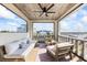 Charming covered balcony furnished with comfortable seating and a ceiling fan at 3006 Christophers Watch Ln, Ruskin, FL 33570