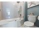 Bright bathroom with a tub and glass shower door, complemented by stylish fixtures and modern tiling at 3006 Christophers Watch Ln, Ruskin, FL 33570