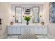 Elegant bathroom featuring double sinks, vanity and white cabinets, with modern lighting at 3006 Christophers Watch Ln, Ruskin, FL 33570