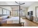 Comfortable bedroom features a four-poster bed, ample natural light, and neutral decor, creating a calming atmosphere at 3006 Christophers Watch Ln, Ruskin, FL 33570
