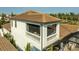 Aerial view of a home showing balcony, brown tile roof, and white exterior at 3006 Christophers Watch Ln, Ruskin, FL 33570
