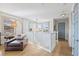 Hallway featuring wood floors, staircase, and a comfortable leather chair at 3006 Christophers Watch Ln, Ruskin, FL 33570