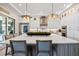 Bright, airy kitchen with white cabinets, stainless appliances, and an island with bar stool seating at 3006 Christophers Watch Ln, Ruskin, FL 33570
