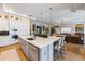 Open-concept kitchen featuring an island with bar seating and a seamless flow to the adjacent living room at 3006 Christophers Watch Ln, Ruskin, FL 33570