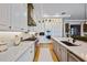 Spacious kitchen with stainless steel appliances, white cabinets, and an island sink with modern faucet at 3006 Christophers Watch Ln, Ruskin, FL 33570