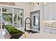 Bright kitchen features stainless steel appliances, a stylish faucet, and sliding glass doors to the outside at 3006 Christophers Watch Ln, Ruskin, FL 33570