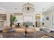 Beautiful living room featuring a large sectional, decorative chandelier, and modern artwork at 3006 Christophers Watch Ln, Ruskin, FL 33570
