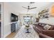 Bright living room with a large TV, comfortable seating, and balcony access at 3006 Christophers Watch Ln, Ruskin, FL 33570