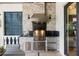 Close-up of an outdoor kitchen featuring a stainless steel grill, sink, and ample counter space for cooking at 3006 Christophers Watch Ln, Ruskin, FL 33570