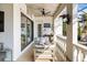 Relaxing outdoor patio with comfortable seating, ceiling fan, and view of the pool and tropical surroundings at 3006 Christophers Watch Ln, Ruskin, FL 33570