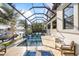 Outdoor living at its finest in this screened in pool area with water views and boat dock at 3006 Christophers Watch Ln, Ruskin, FL 33570