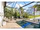 Resort style pool area with outdoor seating and lush tropical landscaping at 3006 Christophers Watch Ln, Ruskin, FL 33570