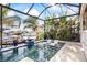 Inviting pool and spa featuring lush tropical landscaping, pool loungers and boat dock at 3006 Christophers Watch Ln, Ruskin, FL 33570