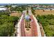 Aerial view of a scenic street lined with charming houses and palm trees at 3006 Christophers Watch Ln, Ruskin, FL 33570