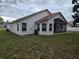 Exterior of home showing the screened patio and spacious backyard at 3292 Dow Ln, Spring Hill, FL 34609