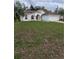 Charming single-story home with well-maintained lawn and a red front door at 3292 Dow Ln, Spring Hill, FL 34609