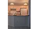 Kitchen features matching appliances with overhead lighting and bar seating at 3292 Dow Ln, Spring Hill, FL 34609