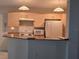 Functional kitchen featuring wooden cabinetry and white appliances at 3292 Dow Ln, Spring Hill, FL 34609