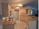 Functional kitchen featuring wooden cabinetry, white appliances, and tiled flooring at 3292 Dow Ln, Spring Hill, FL 34609