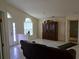 Open living room features tiled flooring, natural light and a decorative china cabinet at 3292 Dow Ln, Spring Hill, FL 34609