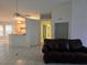 Living room with kitchen and hallway views, and tile floors at 3292 Dow Ln, Spring Hill, FL 34609