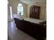 Tile-floored living room includes large front windows and a decorative cabinet at 3292 Dow Ln, Spring Hill, FL 34609