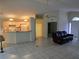 Open living room with kitchen and front door views, and tile floors at 3292 Dow Ln, Spring Hill, FL 34609