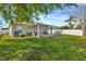Large backyard with a covered patio, ideal for relaxation and entertaining at 3412 Trapnell Ridge Dr, Plant City, FL 33567