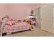 Cozy pink bedroom with a plush bed and a playful collection of stuffed animals at 3412 Trapnell Ridge Dr, Plant City, FL 33567