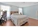 Well-lit bedroom with wood floors, comfortable bed, and ample natural light at 3412 Trapnell Ridge Dr, Plant City, FL 33567